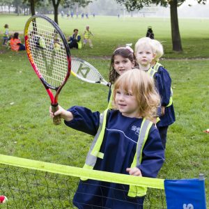 4 students playing tennis