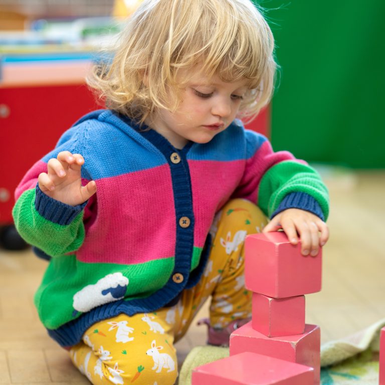 student stacking blocks