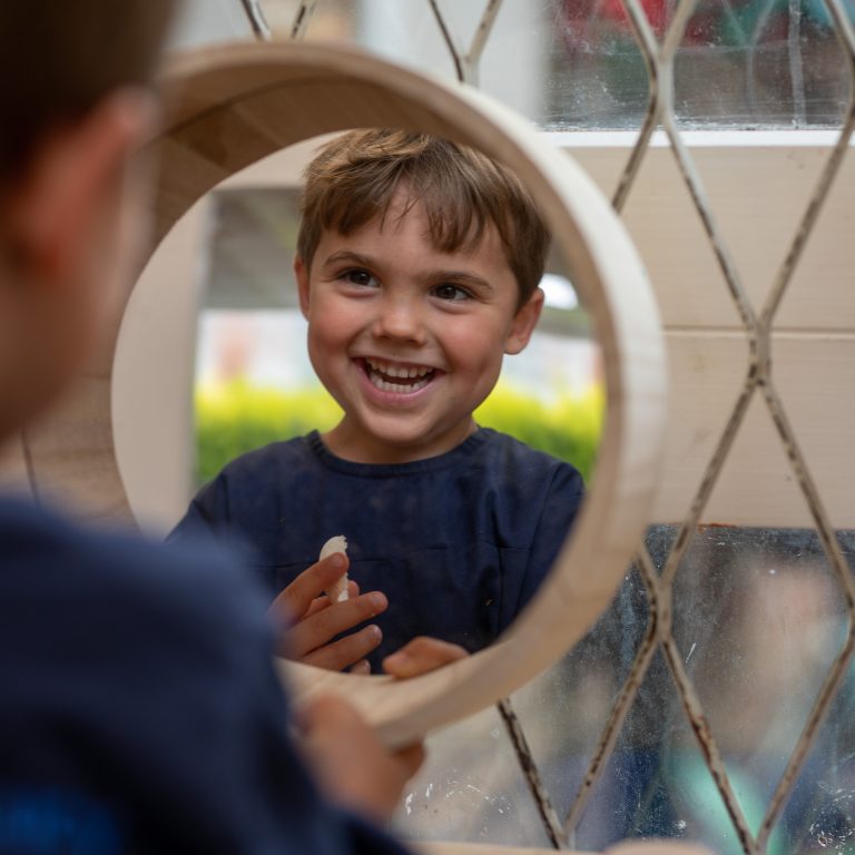 boy looking through mirror