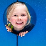 child looking through a hole