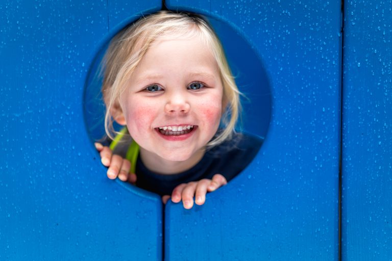 child looking through a hole