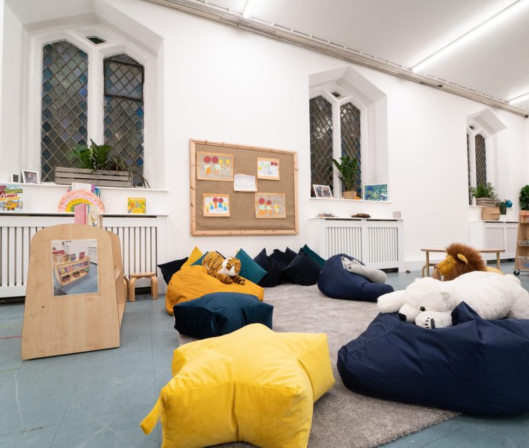 bean bags across the room with different animal plushies on them