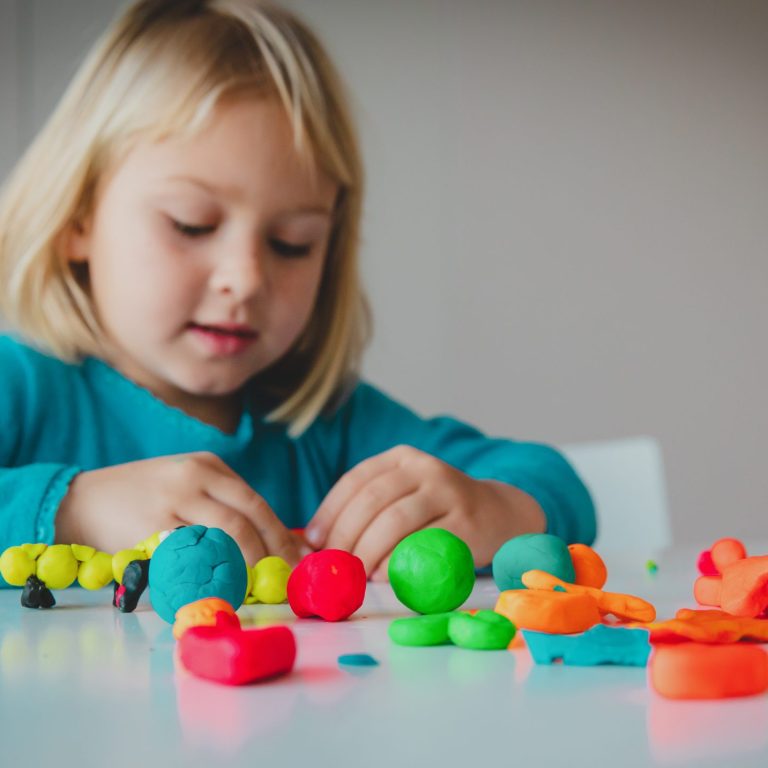 Child Playing With Clay Moulding Shapes